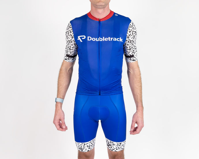 front view athletic man wearing tight fitting spandex cycling jersey and cycling bibs